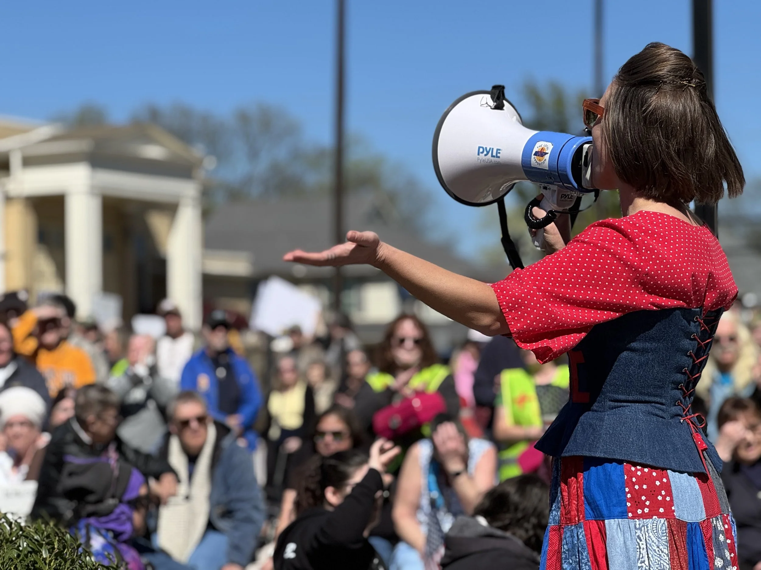 Mandy speaking to a crowd with a megaphone