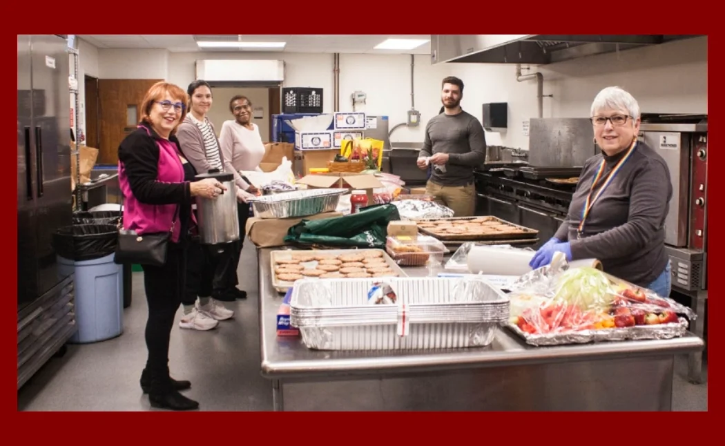 5 volunteers in a church kitchen preparing food for an event