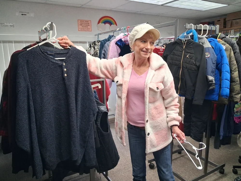 Volunteer hanging up clothing