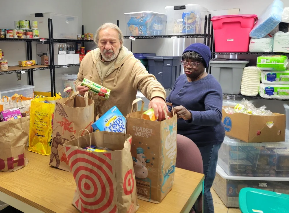 Volunteers preparing bags off food