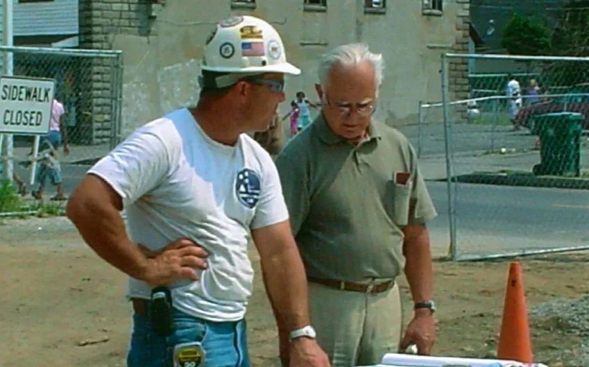 LeChase Site Supervisor Ed Polle (left) and volunteer architect and ESWA Advisory Committee member Pete Romeo (right) review the building plans.