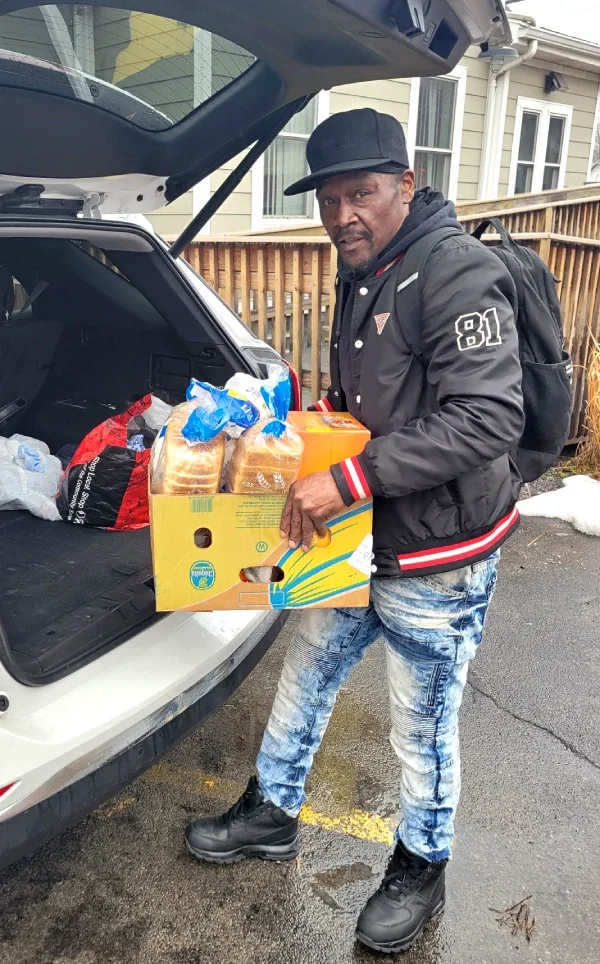 man loading food box in an SUV