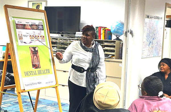 healthcare professional pointing at a chart for dental care