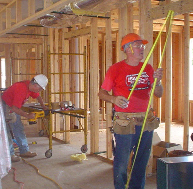 Jim Isaac (right), owner of Isaac Heating and Air Conditioning, personally volunteered to install all the donated heating and air conditioning equipment. 