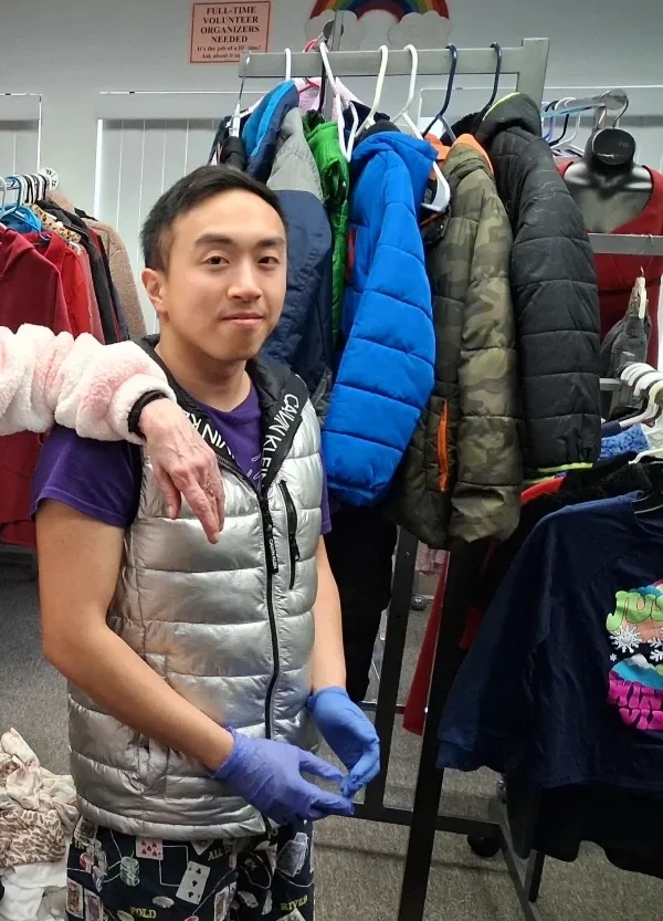 young man posing with benefit clothing