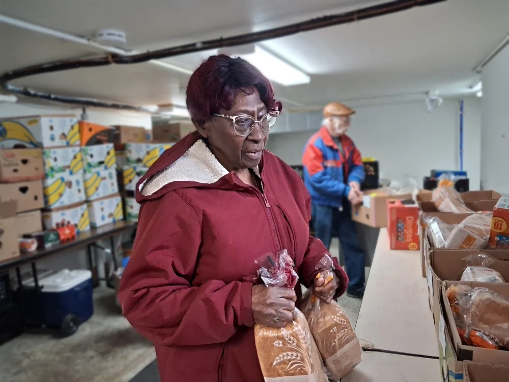 Volunteer filling boxes with food