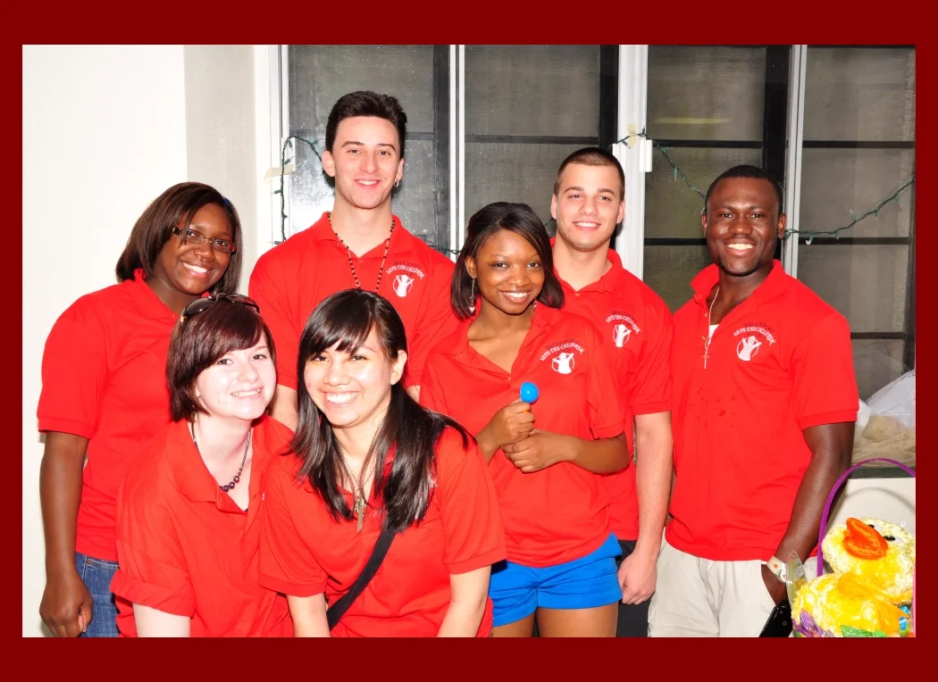 Group of volunteers wearing match red shirts