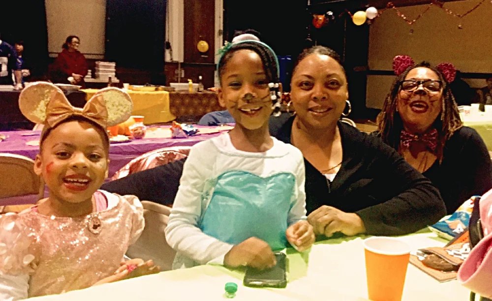 photo oa two girls and 2 women in fancy easter clothes at an Easter Party