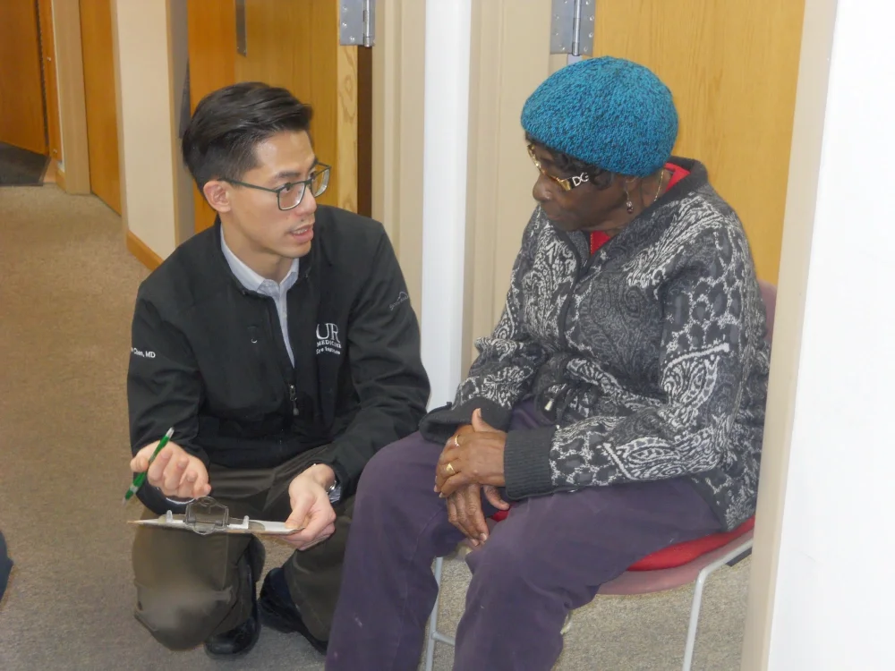 health care worker interviewing a woman writing on a clipboard