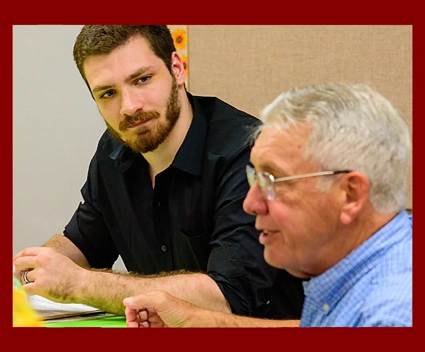 a young man and older man having a discussion