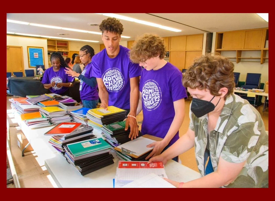Student volunteers sorting back to school supplies