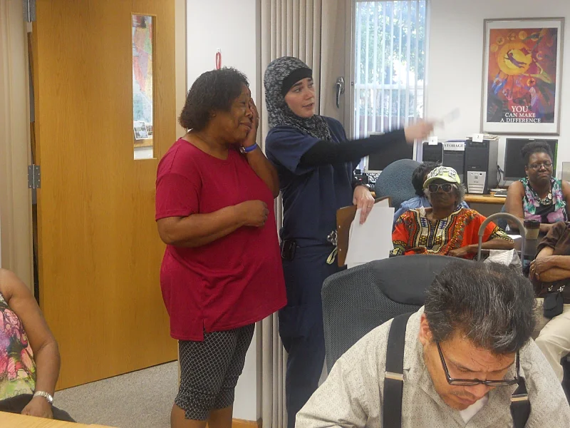 woman pointing to guide a women to a health care event