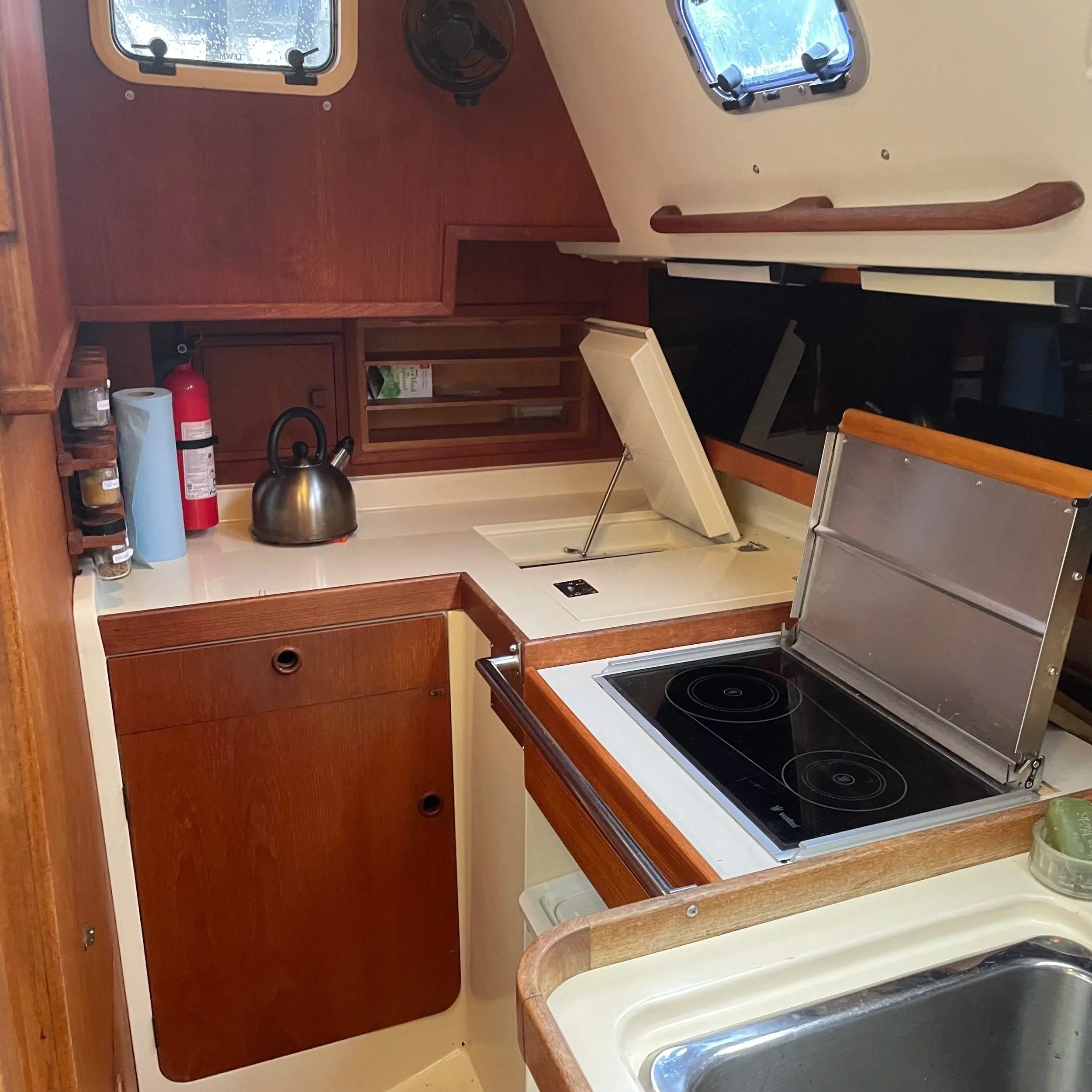 A fully equipped galley with counter room and storage for even the most committed cooks. It features a top loading fridge, Wallas diesel cooker, and double sink pushed forward to be closer to the center line. 