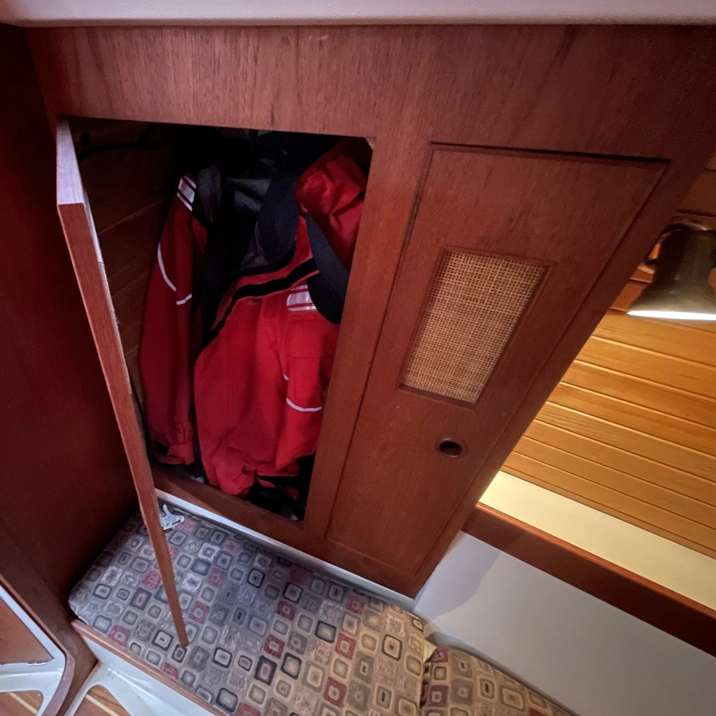 Hanging locker and shelves for clothes in rear cabin. 