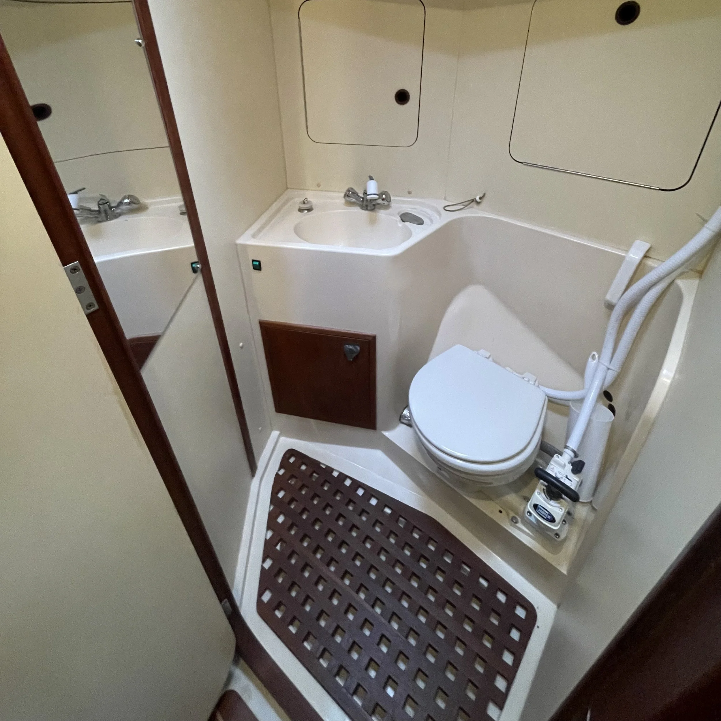 Head includes handheld shower with bilge pump for draining. Plenty of good storage for toiletries and first aid kit.