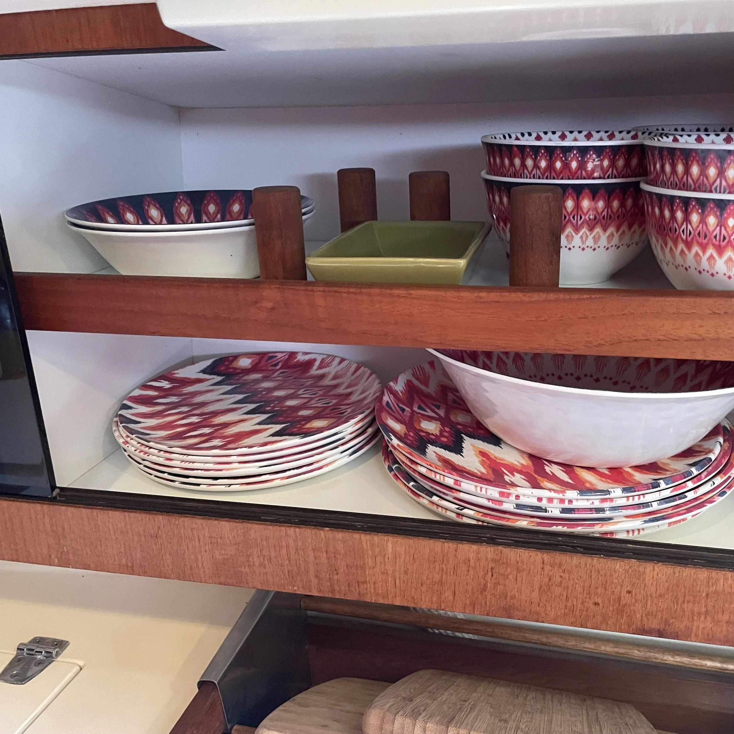 Storage above the stovetop/heater. Dishes come with boat.