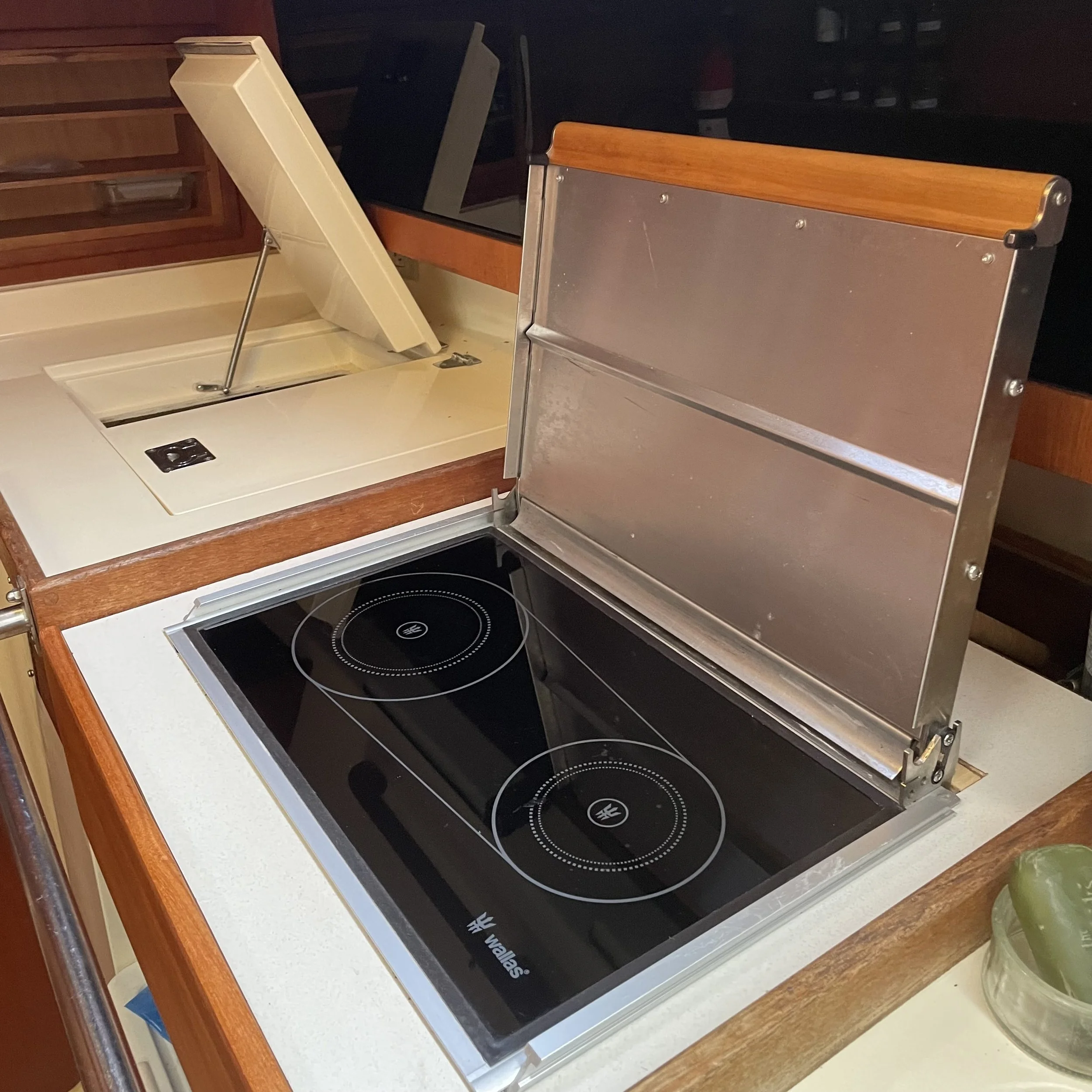 Wallas brand (Finland) diesel powered stovetop that also becomes a space heater when the top is down. There is no oven so more storage underneath. 