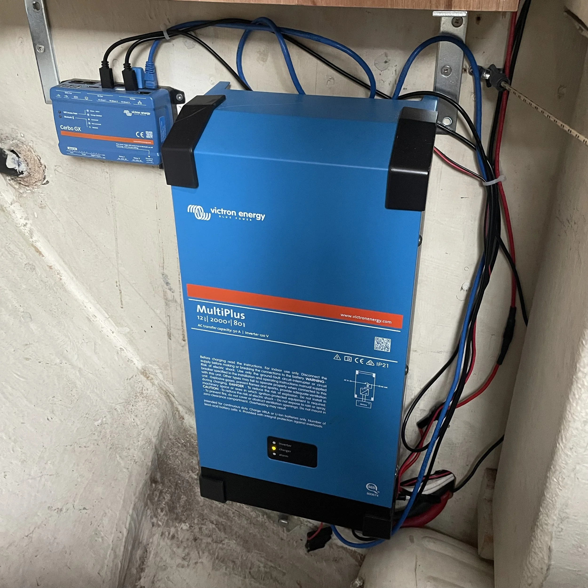 Victron MultiPlus Inverter and charger for 200A LFPO house bank. Cerbo GX acts as brain for MultiPlus, Victron Solar Controller and Victron Orion DC-DC Charger and enables offsite monitoring of the electrical system (charging and discharging) over th