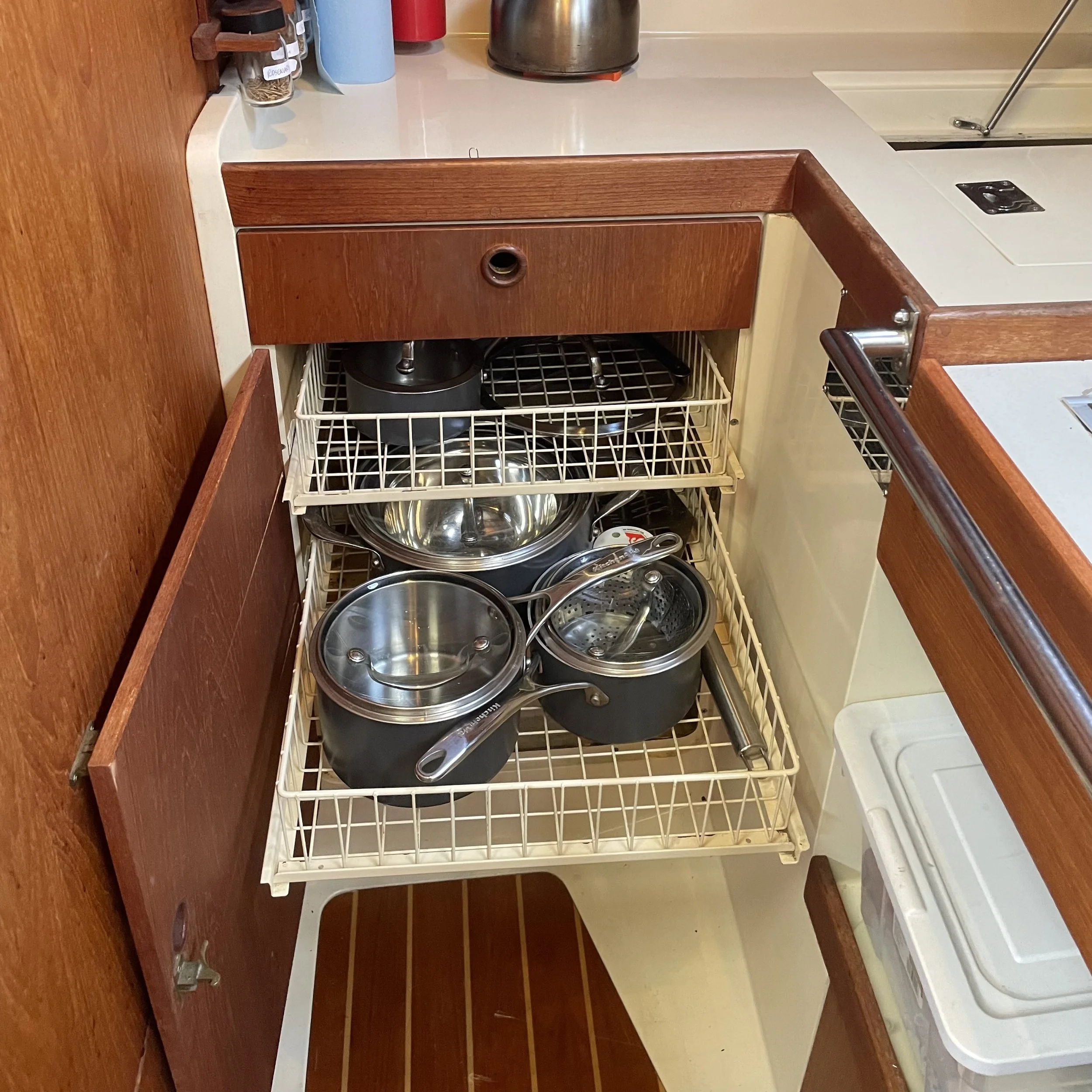 Removable racks for full set of pots. The LiFPo 200A/hr house bank is under these racks. 