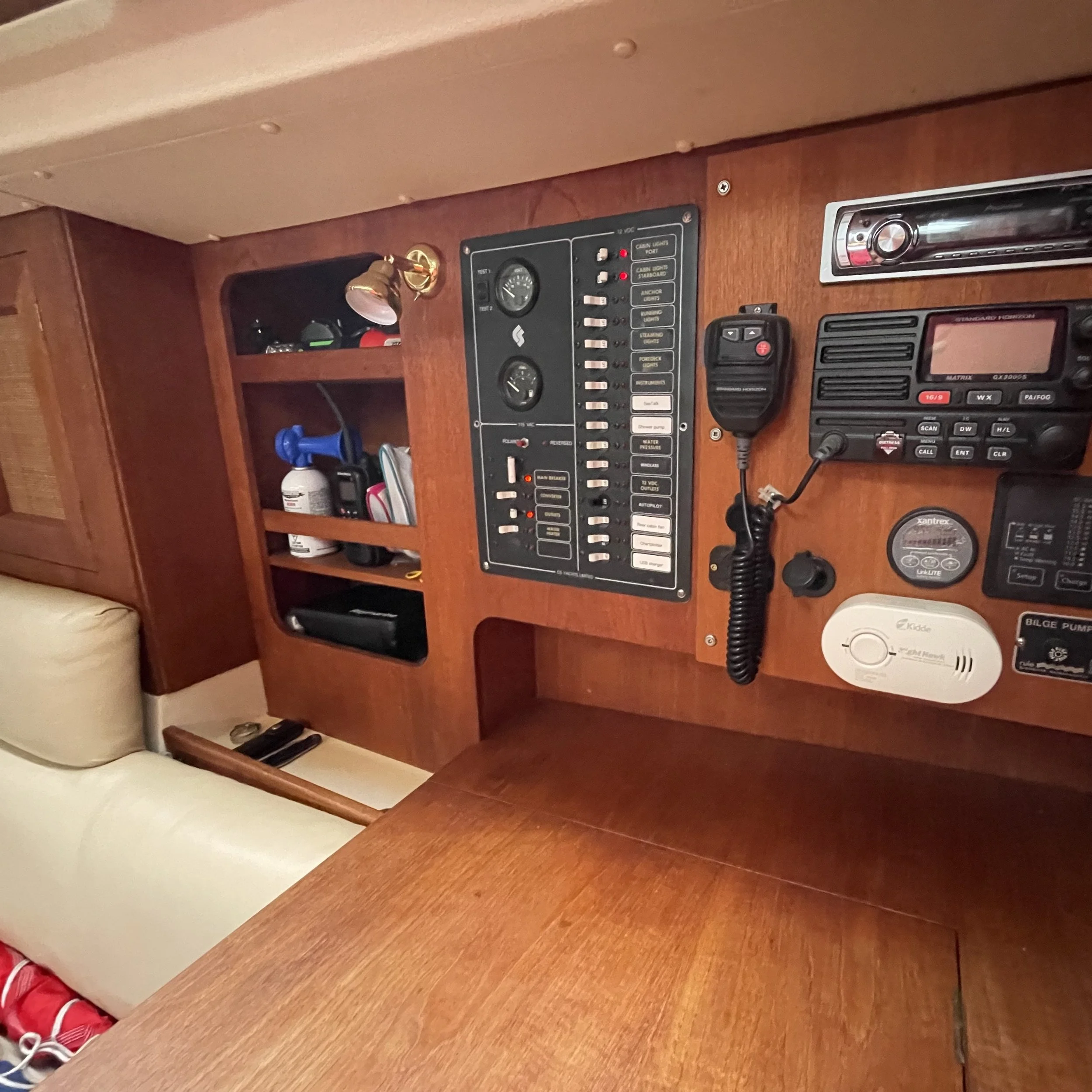 Navigation table and electronics panel. Great for planning passages and making log entries. Along with the pictured VHS radio, there is a handheld VHS in the shelves. Also pictured are USB charger ports and cigarette lighter charger, as well as an on
