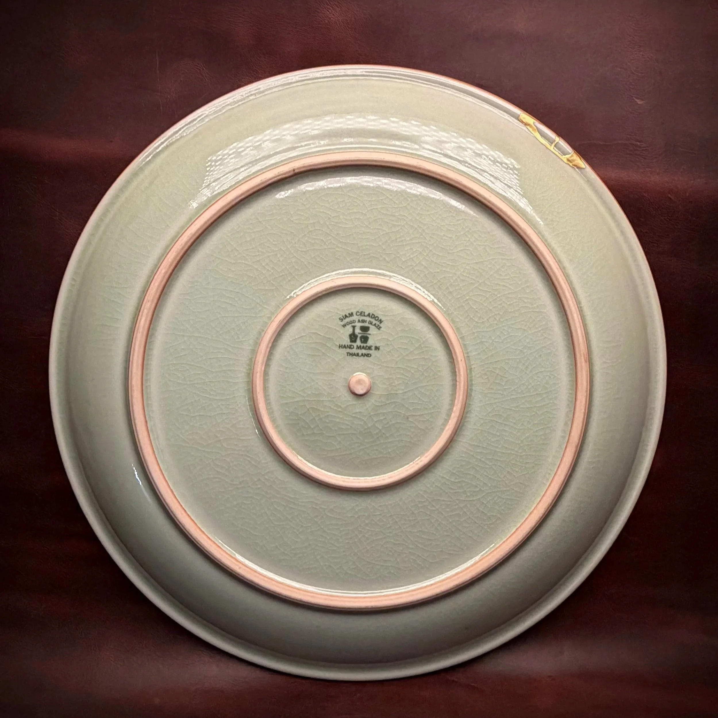 This enormous platter is one of the larger pieces I’ve had the opportunity to repair. Its owners purchased it during their honeymoon in Thailand 30 years ago, and the traditional wood-ash celadon glaze is absolutely beautiful.

The damage itself was 