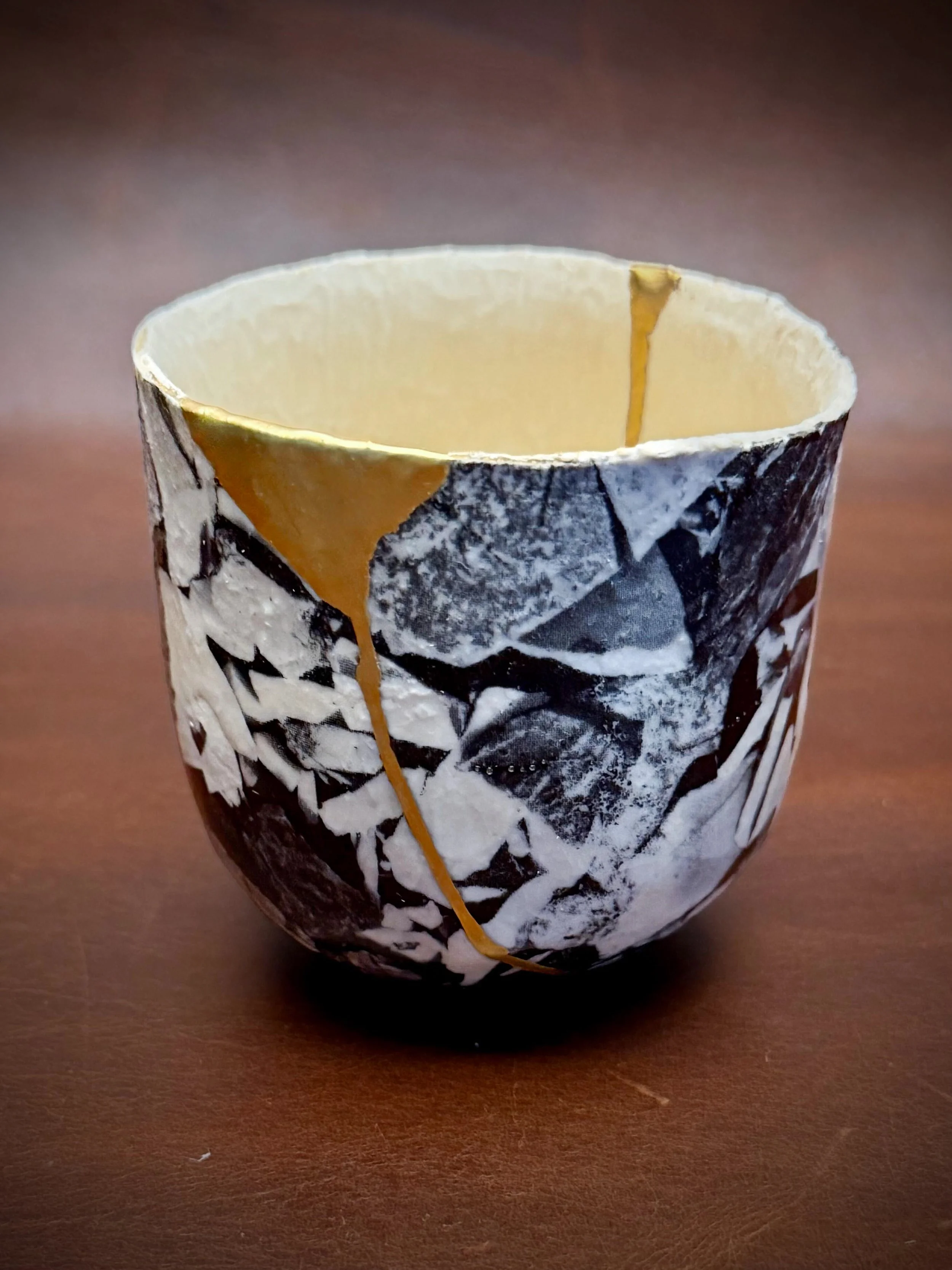 The owner of this cup was introduced to the artist by a friend of his, who unfortunately has passed. I loved its bold black-and-white pattern and rough, textured surface, and intentionally left a little texture beneath the gold so the repair would fe