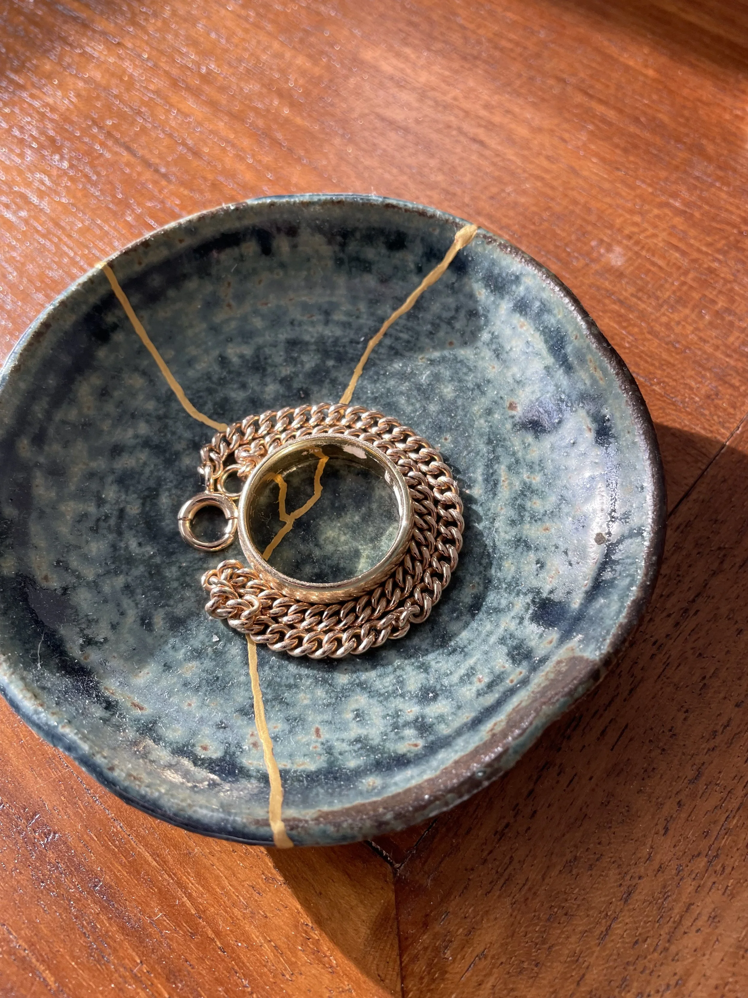 Small blue jewelry plate repaired with kintsugi