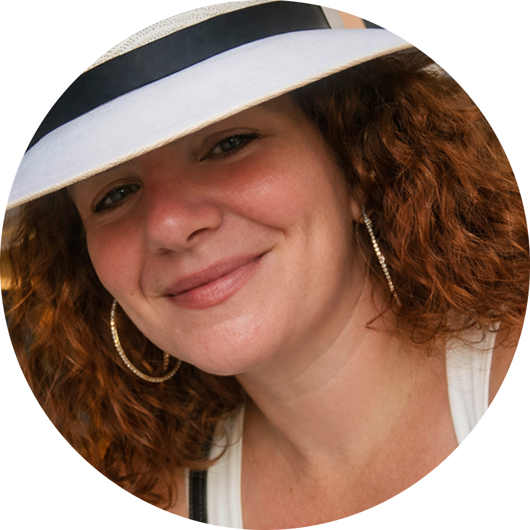 Close-up of Amanda Navarra, founder of Epicurious Adventure travel, smiling at the camera.