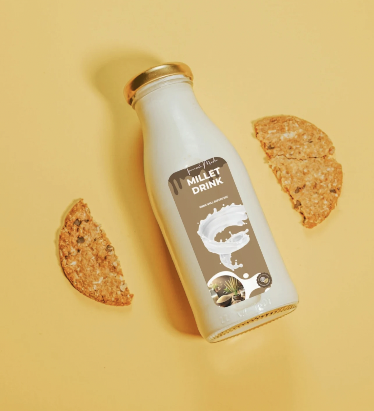 A bottle labeled 'Millet Drink' with two oatmeal cookies on a yellow background.