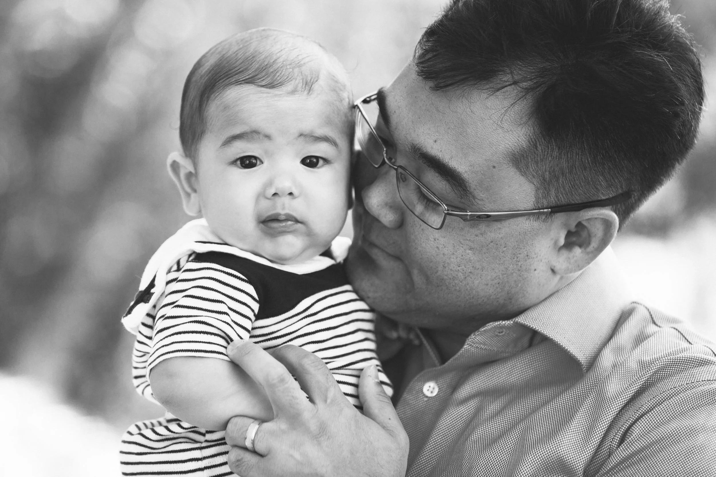 Pacific asian father and son smiling for family portraits