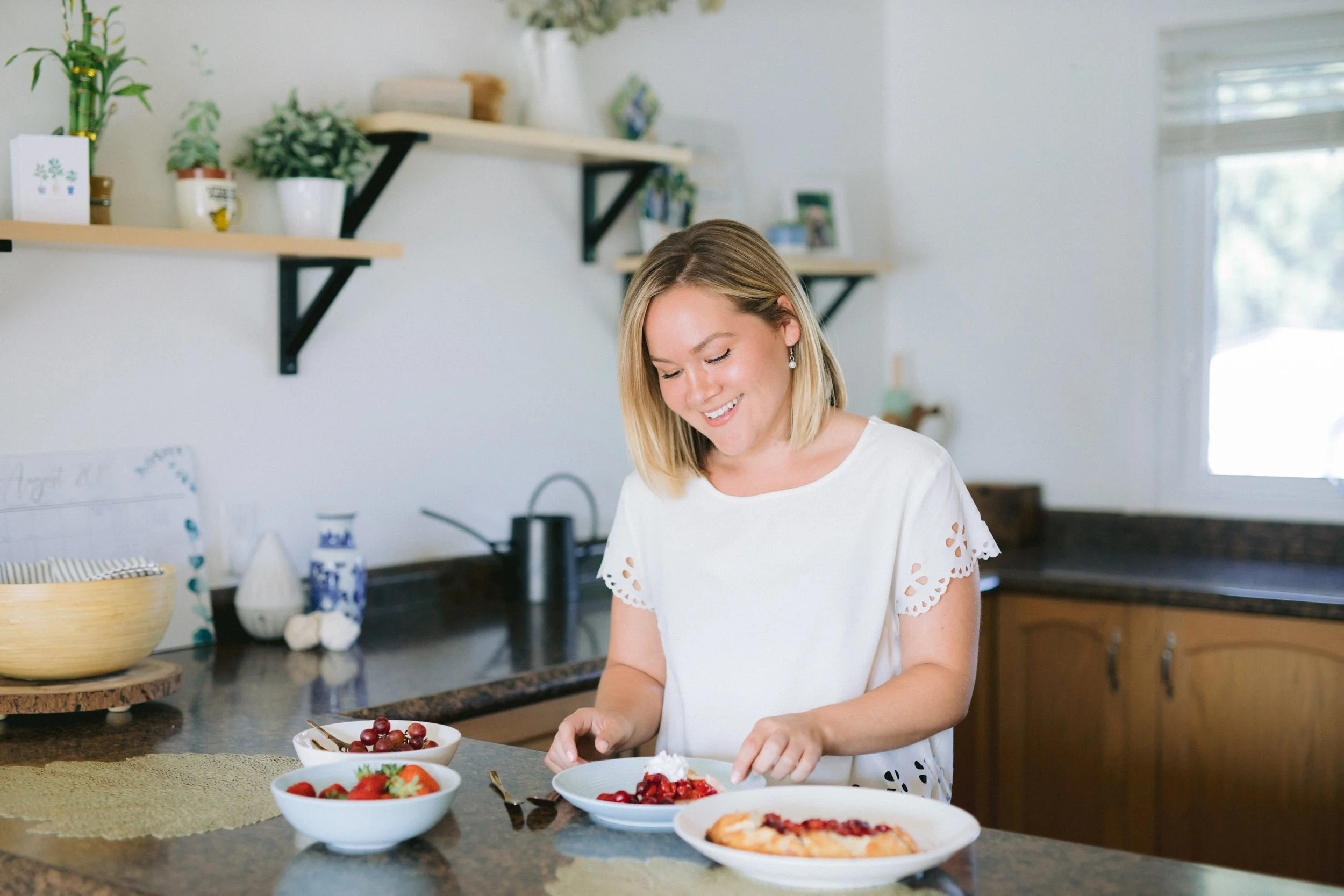 postpartum doula prepares delicious, healing food for client in a neutral kitchen