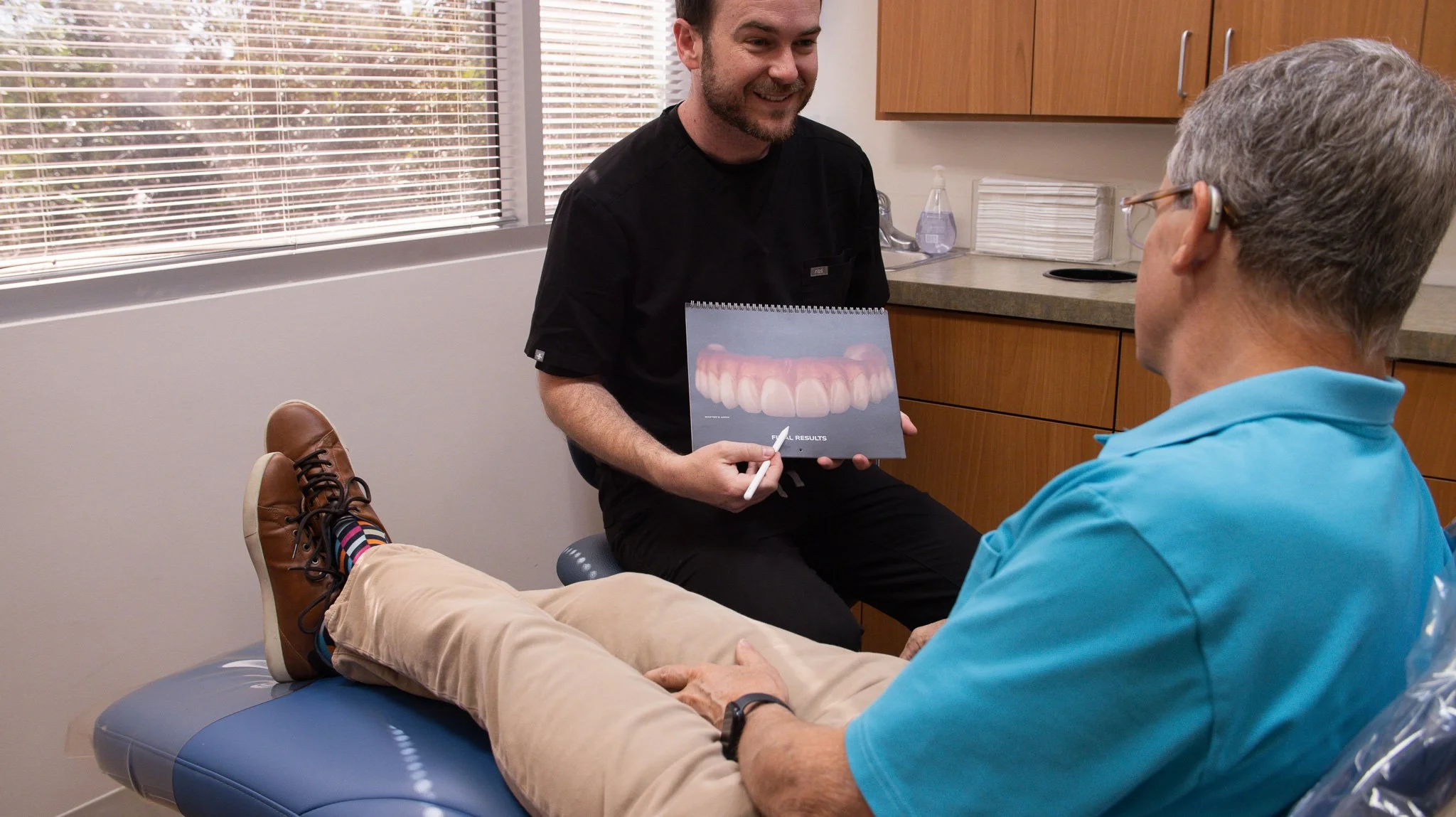 Phoenix prosthodontist Dr. Lassiter explaining denture options to a patient during a consultation