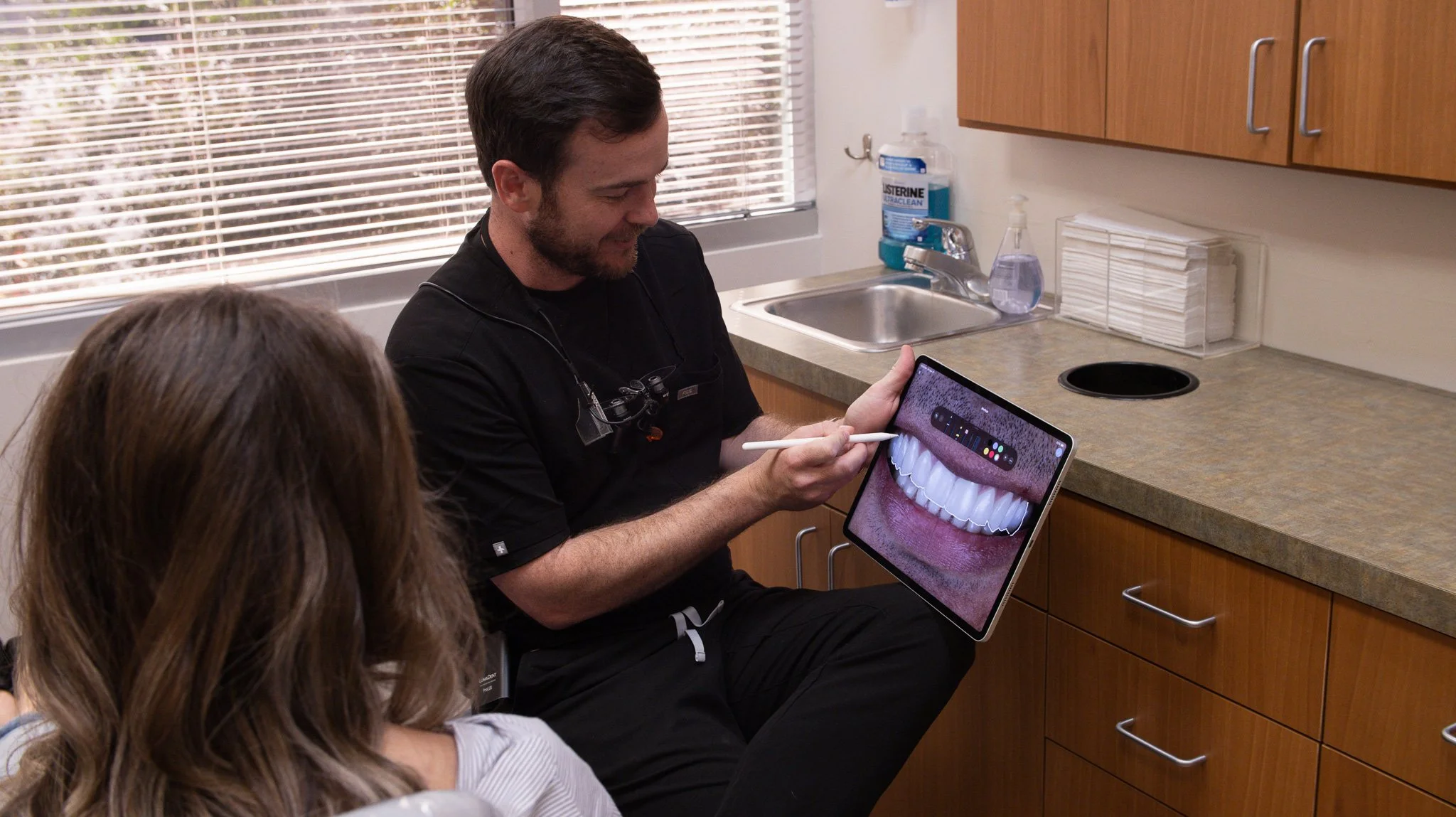 Phoenix prosthodontist showing a patient a digital smile design during a cosmetic dentistry consultation