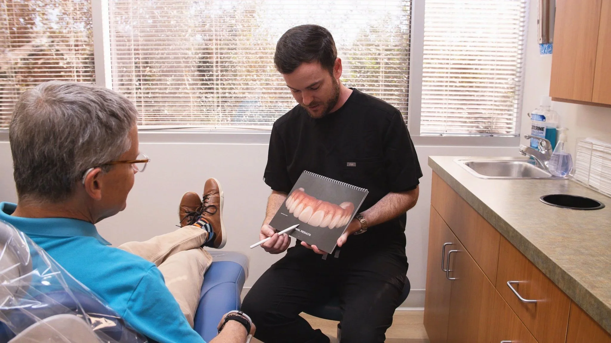 Phoenix prosthodontist Dr. Lassiter explaining denture options to a patient during a consultation