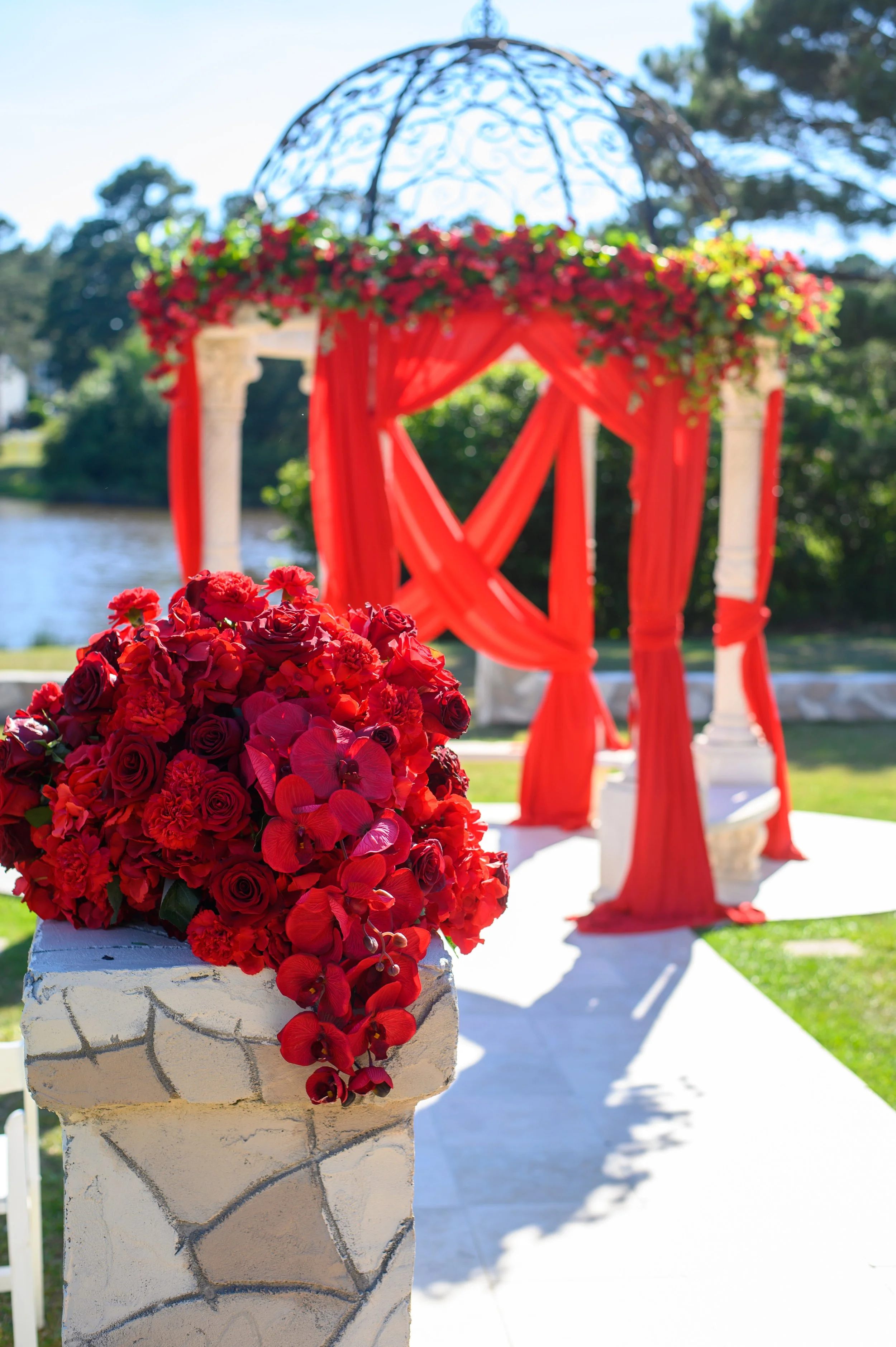 Unique Rose Events and Designs Purgala Draping flowers outside Red Gold black.jpg
