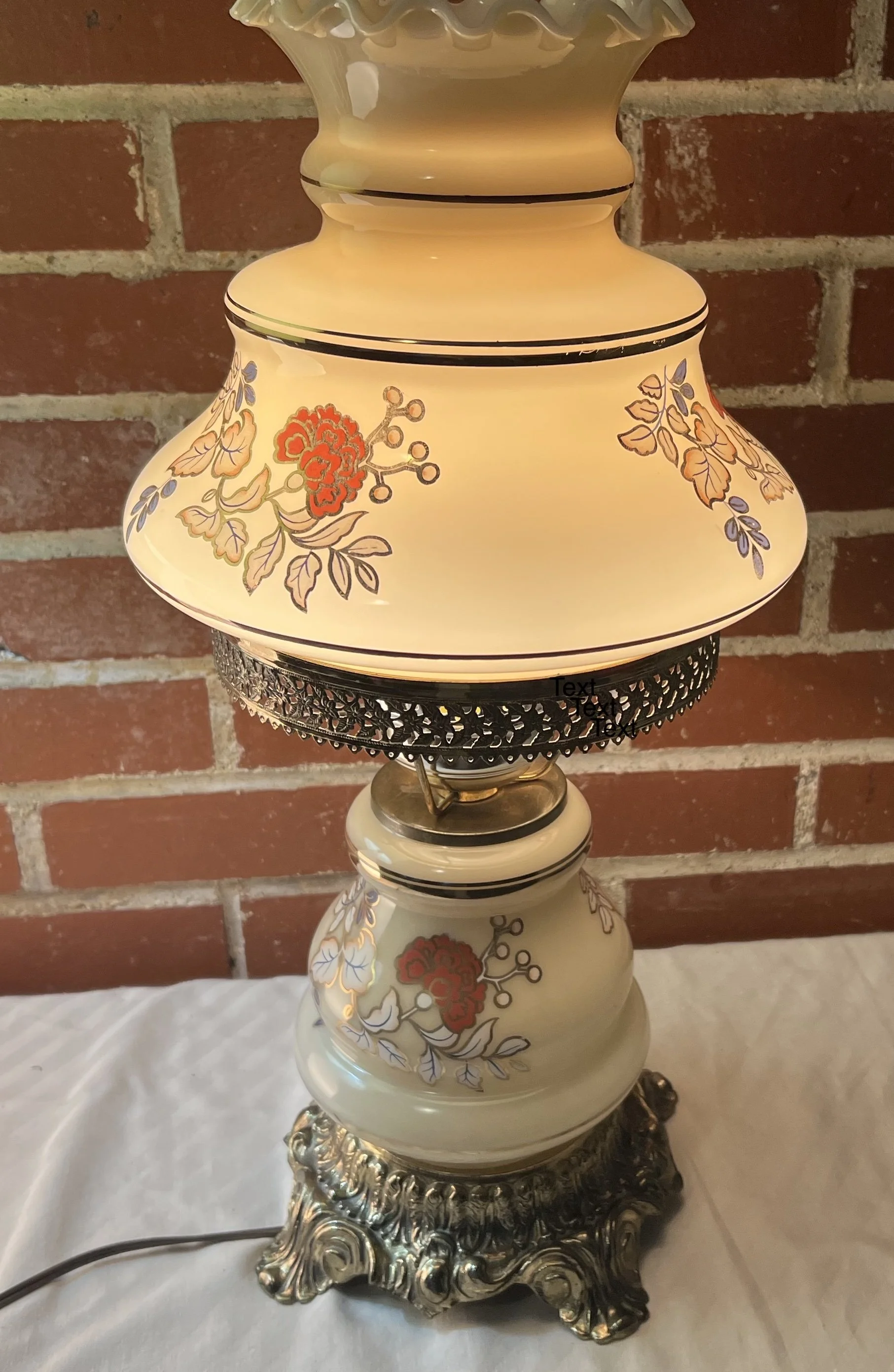 This item is a vintage "Gone with the Wind" (GWTW) style hurricane parlor table lamp featuring hand-painted floral patterns. 
Style: Victorian/Antique reproduction parlor lamp.
Design: Features a dual-globe design with intricate floral motifs in oran