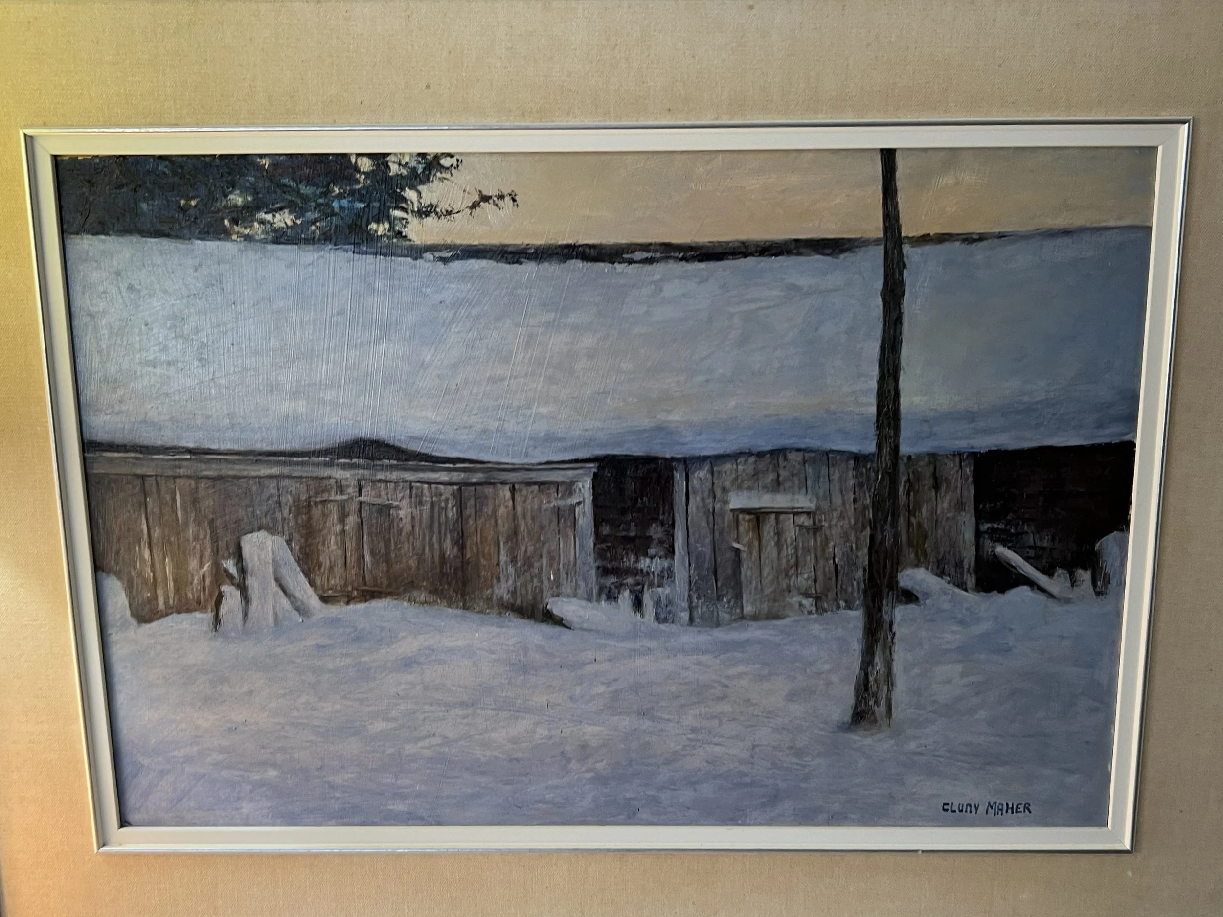 This image is a painting titled "Winter Scene" created by Canadian artist Cluny Maher. 
The artwork features a rustic wooden barn completely covered by a thick blanket of snow.
The composition is dominated by a minimalist palette of whites, blues, an