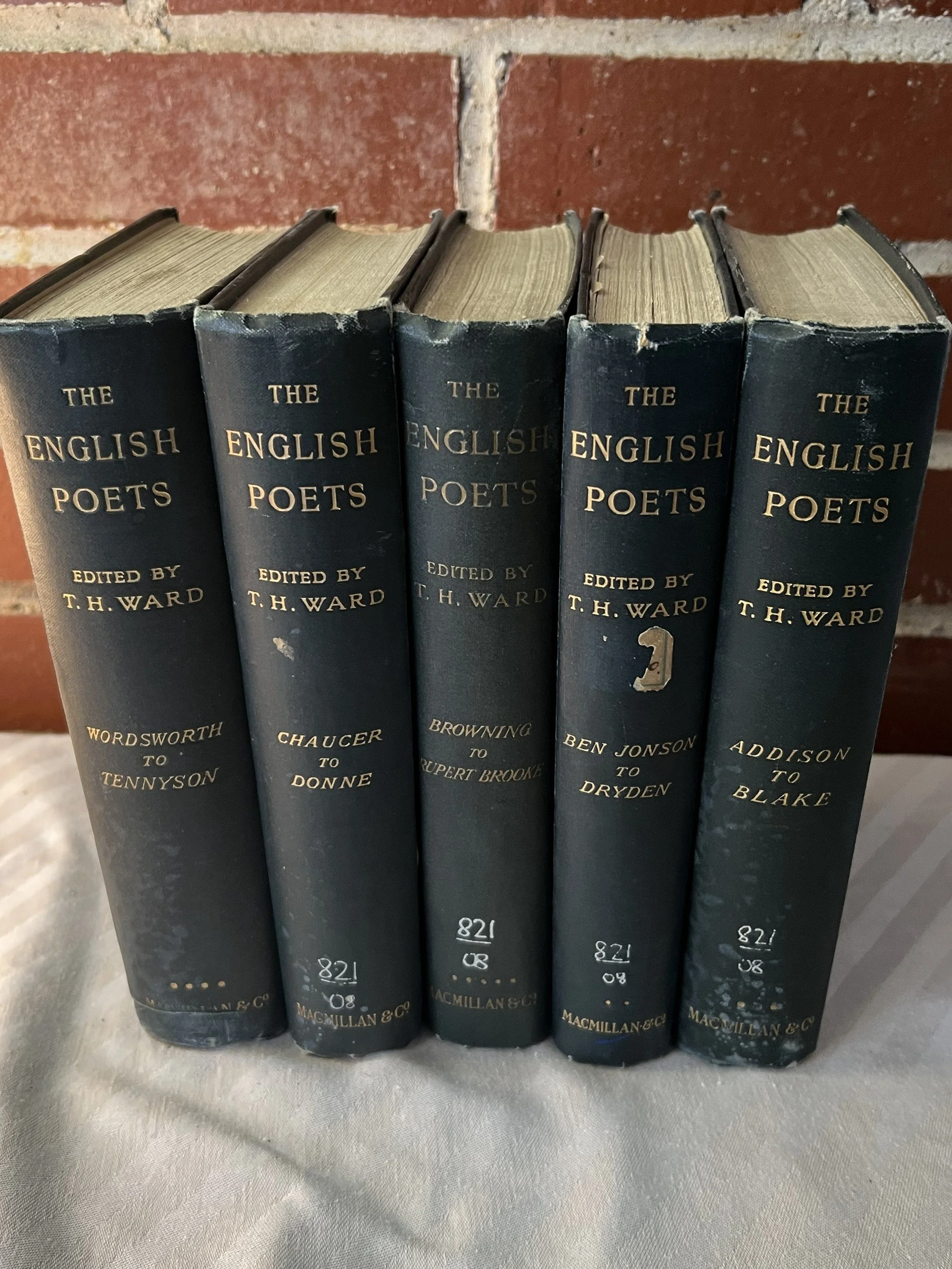 A collection of five vintage hardcover books titled 'The English Poets,' edited by T. H. Ward.