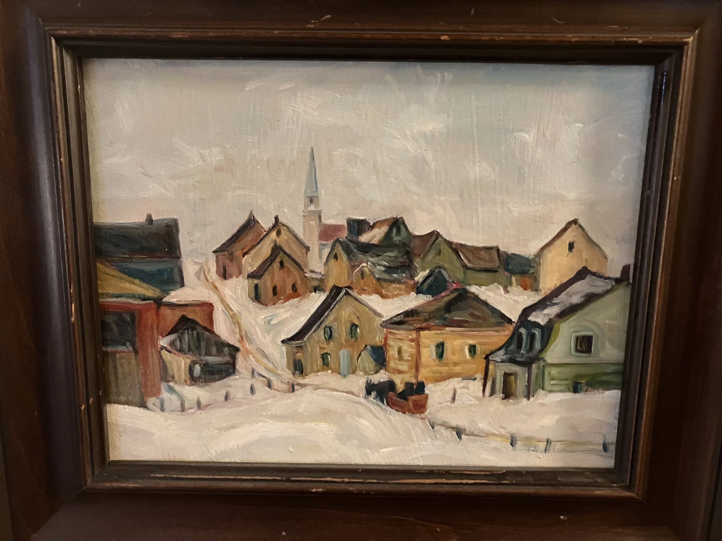 Oil painting of a snowy village scene with houses and a church steeple, framed in dark wood.
