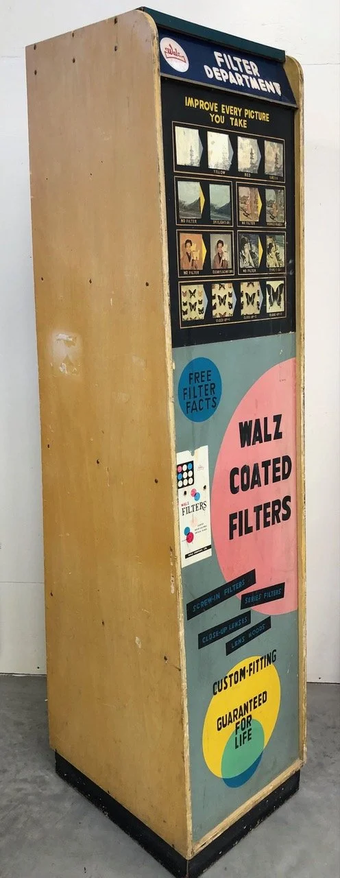 Vintage Walz Coated Filters display and vending machine from the 1950s or 1960s. This floor-standing unit, labeled as a "Filter Department," was designed to educate photographers on how different lens filters can improve their pictures and to dispens