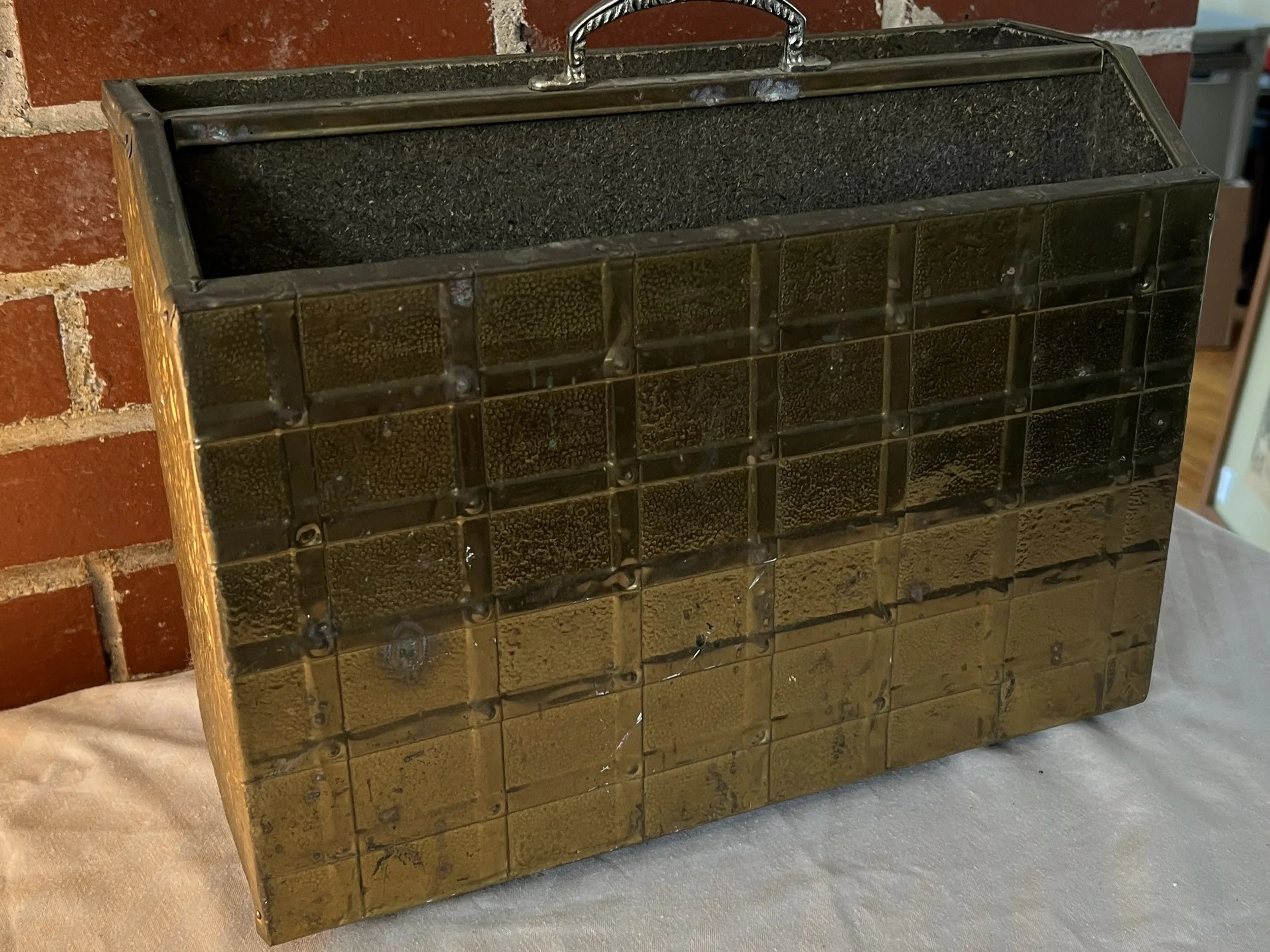 A vintage wooden and metal paper rack