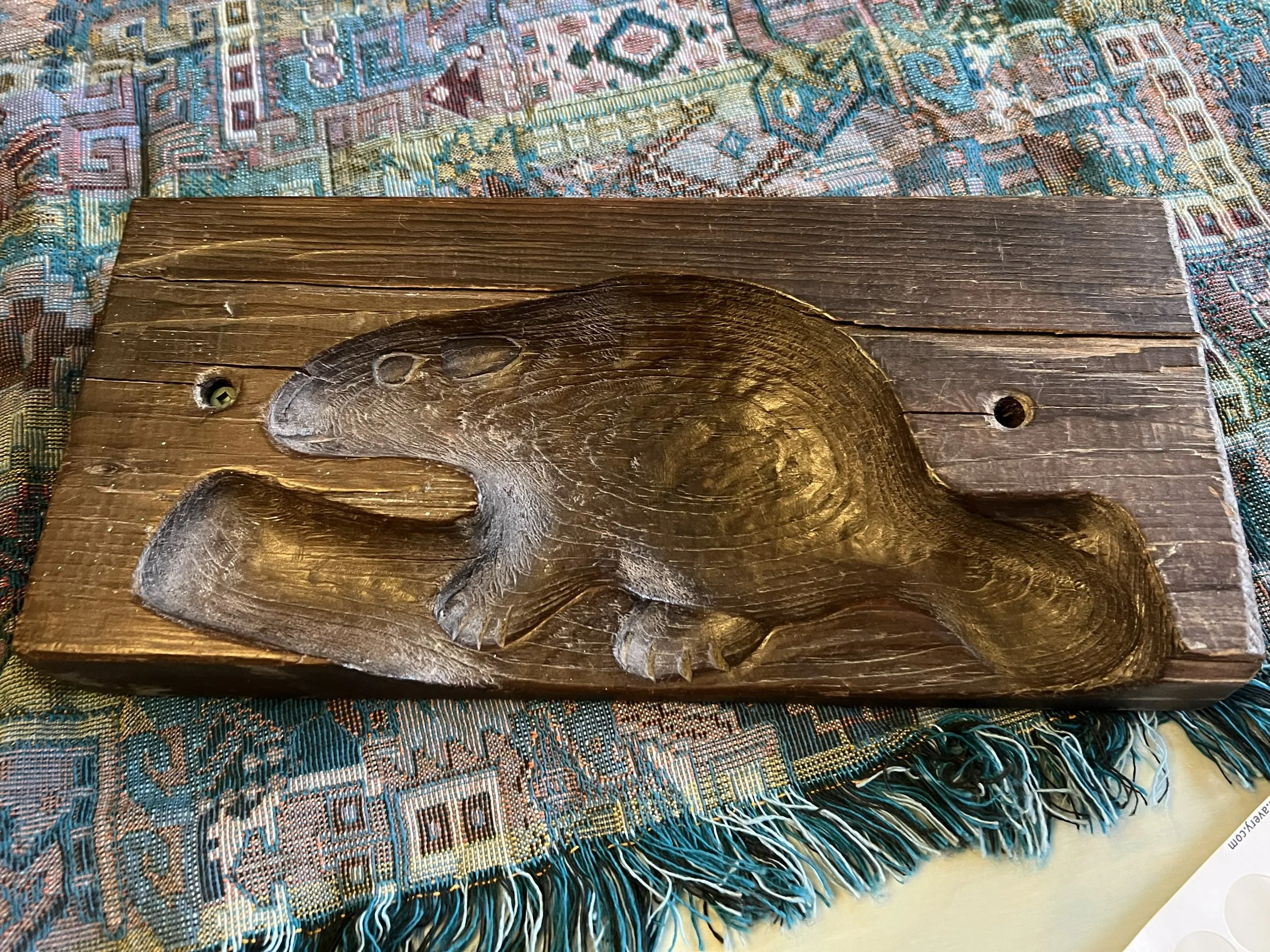 This antique wooden item is a maple sugar mold, specifically a hand-carved piece used to shape maple sugar into solid cakes. 
Historically, these molds were used in Quebec, Canada, during the 19th and early 20th centuries. When maple sap was boiled d
