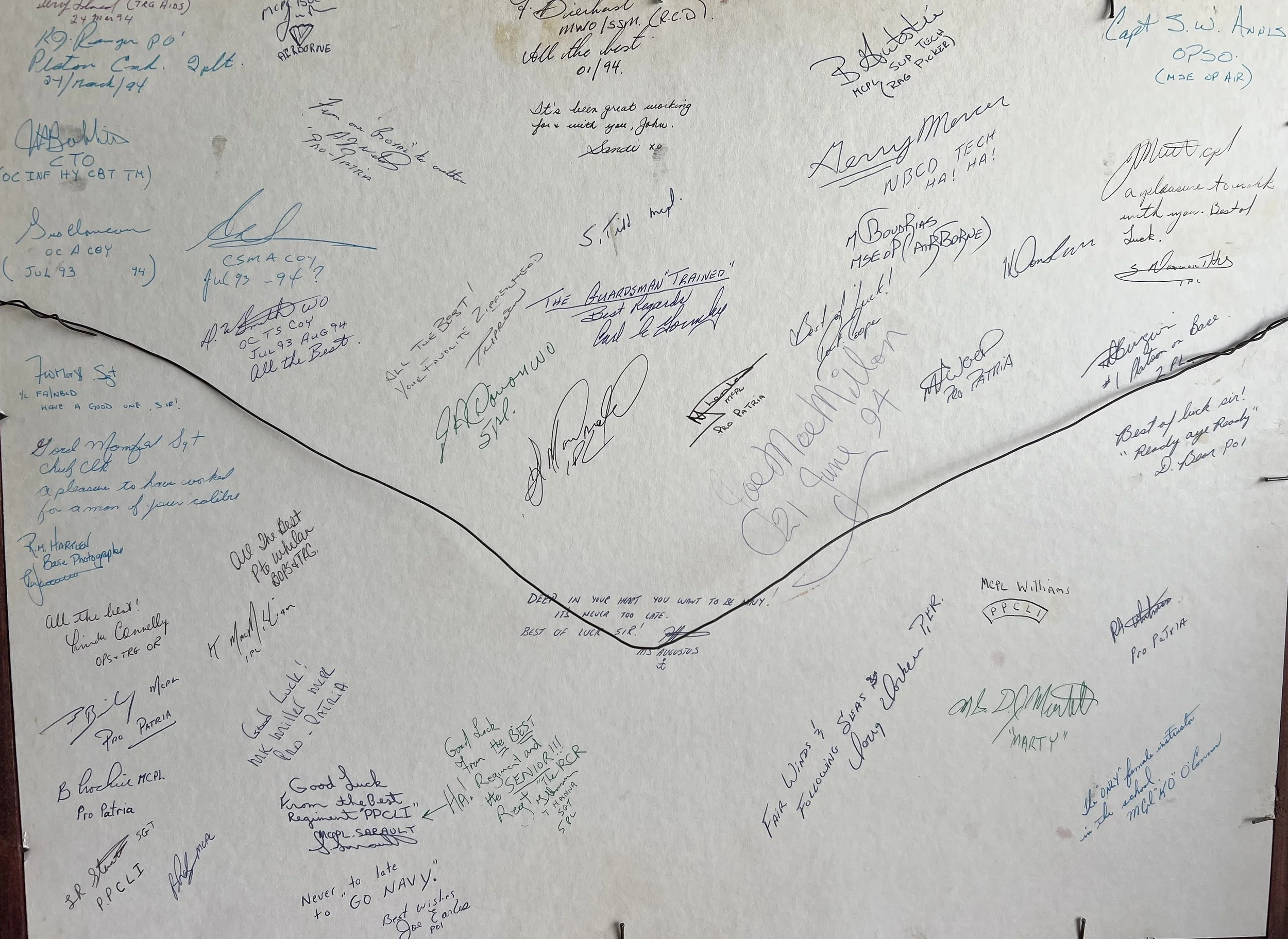 The image depicts the signatures and well-wishes found on the back of a graduation photograph from CFB Cornwallis (Canadian Forces Base Cornwallis), a major recruit training facility in Nova Scotia that operated until 1994. 
These signatures represen