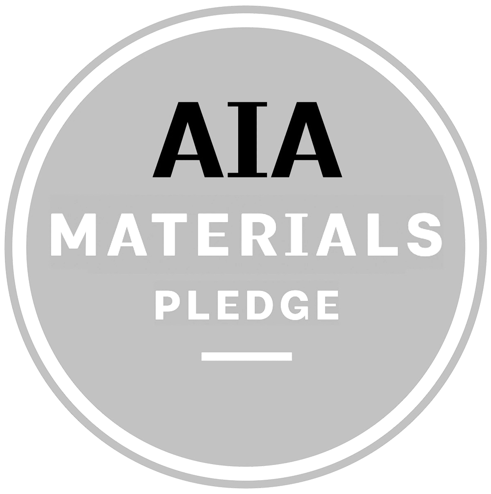 A circular badge with a black and grey border, featuring the text 'AIA MATERIALS PLEDGE' in black and white letters.
