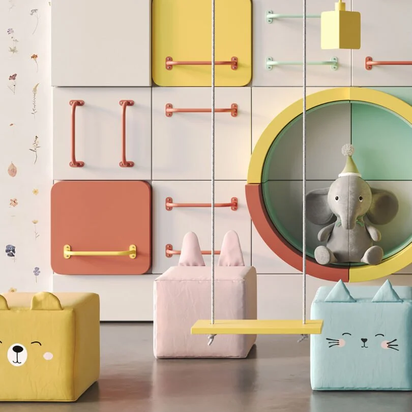 Colorful children's room with soft storage boxes shaped like a bear, bunny, and cat, a plush elephant toy in a round cubby, and a hanging yellow swing in front of a wall of storage squares with various colored handles.