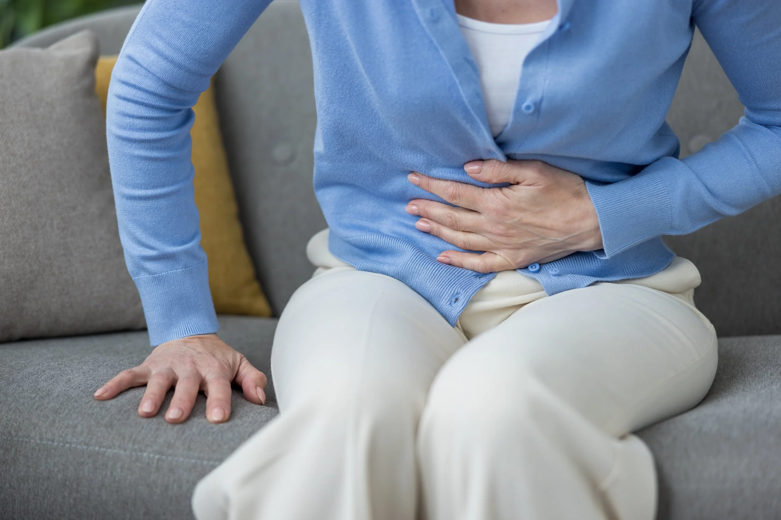 Person experiencing abdominal discomfort from bloating