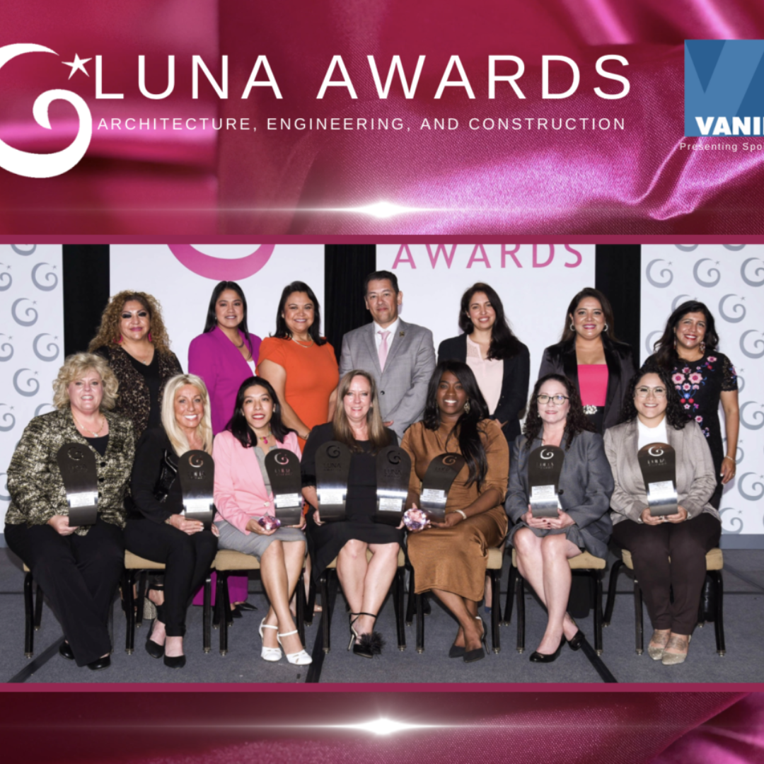 Group of women and one man at the Luna Awards for architecture, engineering, and construction, holding awards and posing for a group photo on stage.