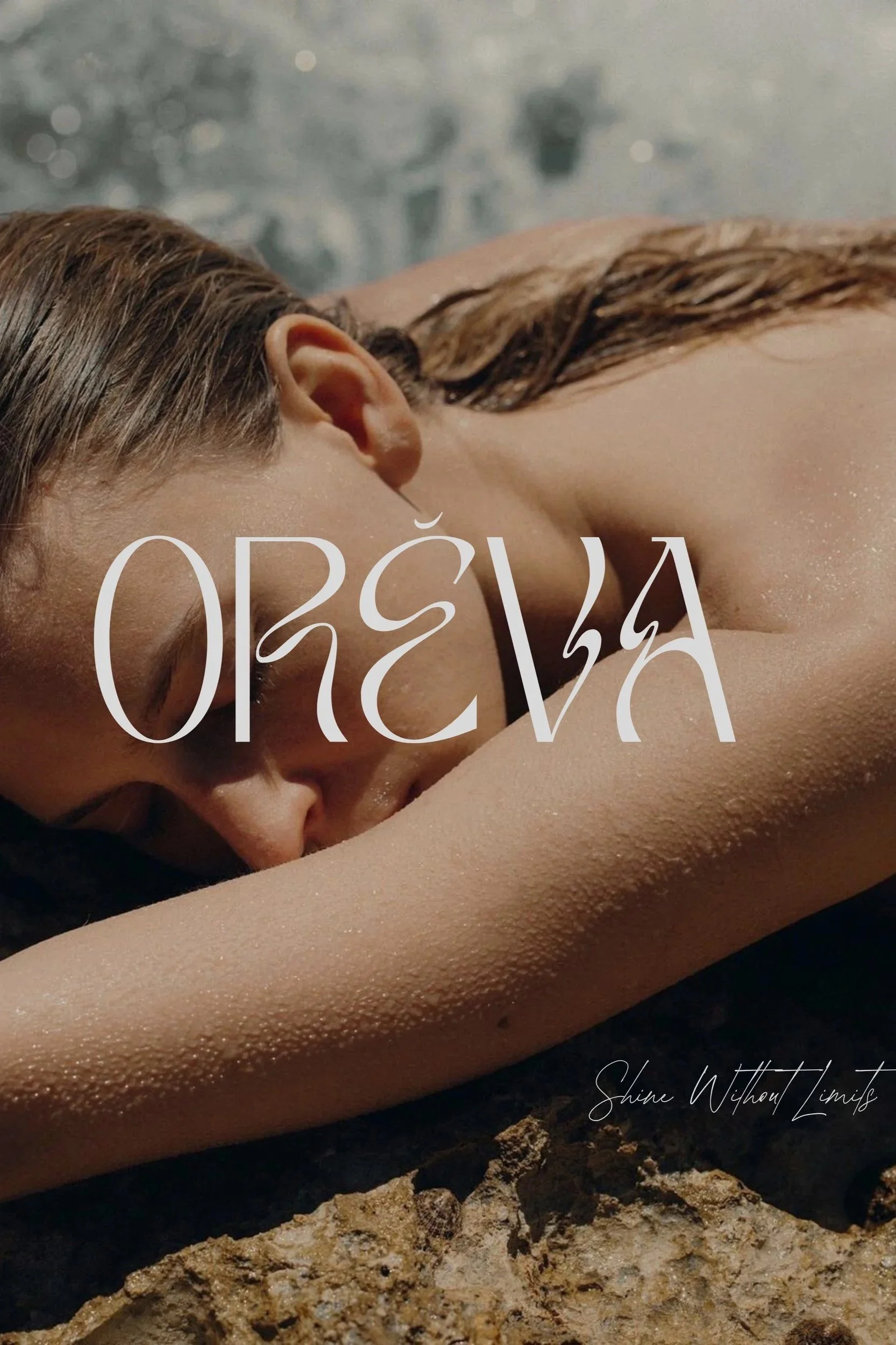 Close-up of a woman with wet hair lying face down on a rock, with the word ORÉVA overlayed in large text and a signature reading Shine Without Limits.
