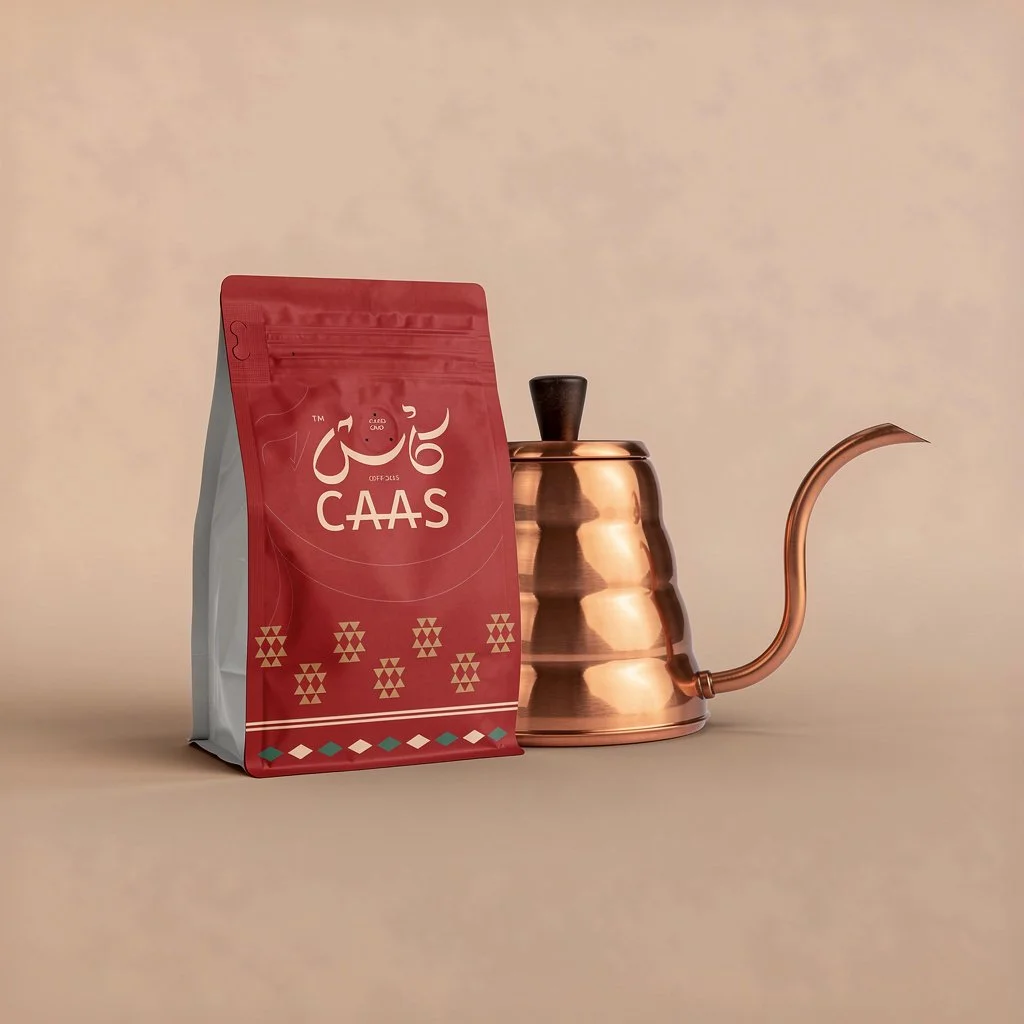 A red and white bag labeled 'CAAS' next to a copper pour-over coffee kettle.