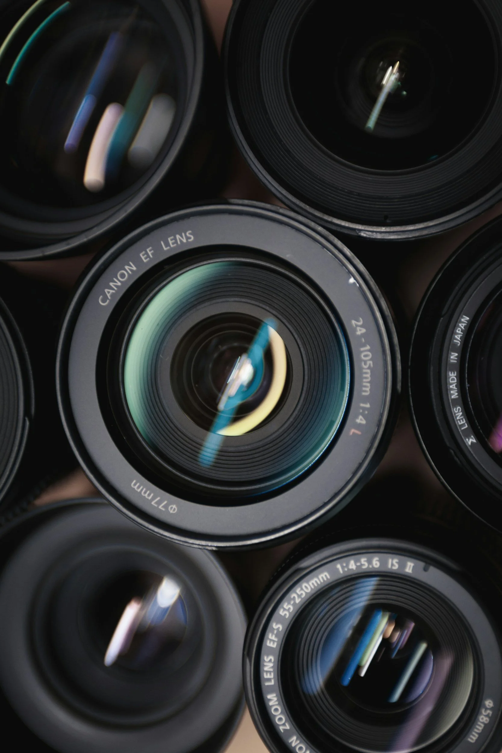 Close-up view of multiple camera lenses arranged in a cluster, showing detailed glass elements and markings.